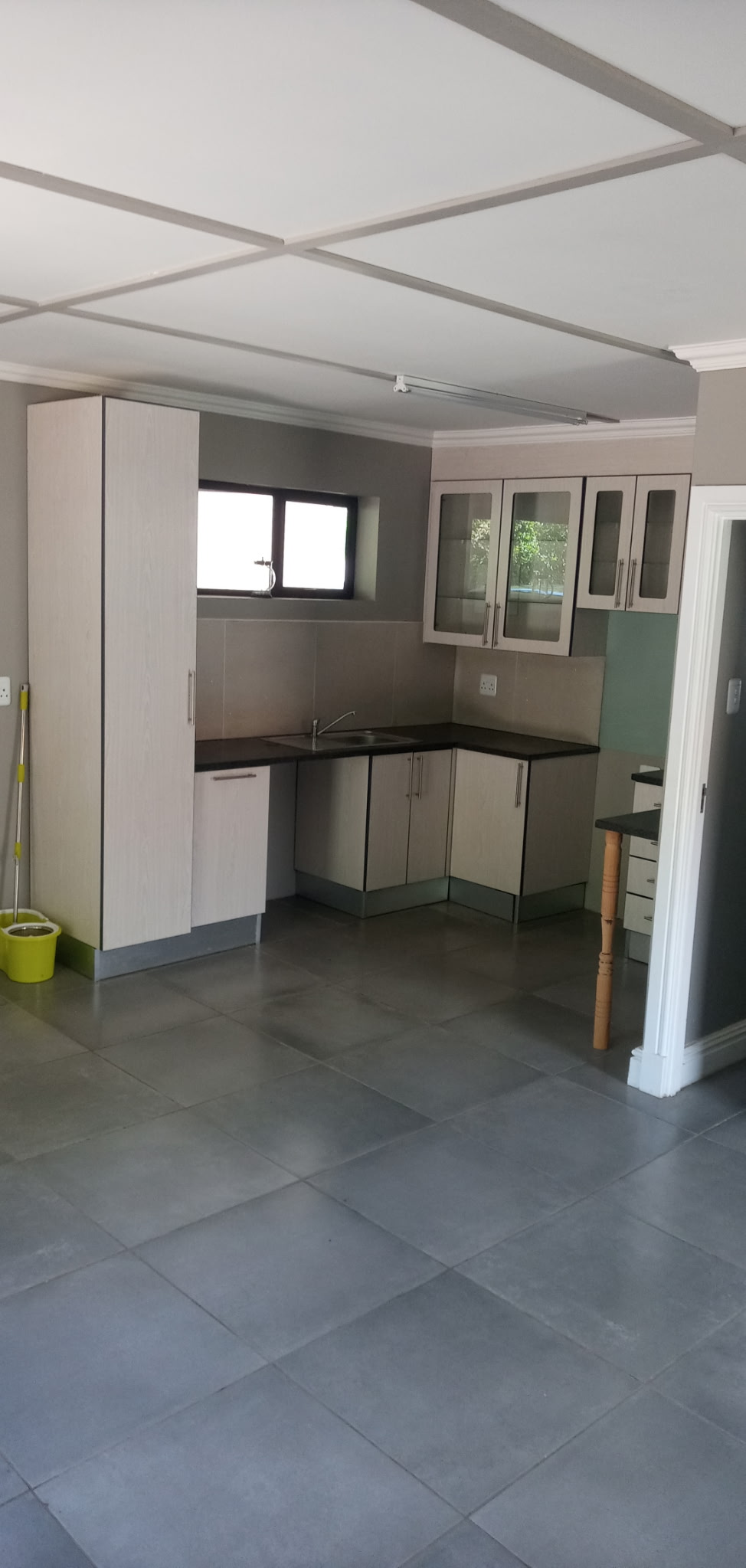 Cottage kitchen conversion with black cherry cabinets, slate grey edging and granite worktop